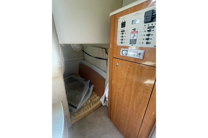 Slide: The Image of 2002 Maxum 2700 SCR cabin interior with control panel and storage area. - 16