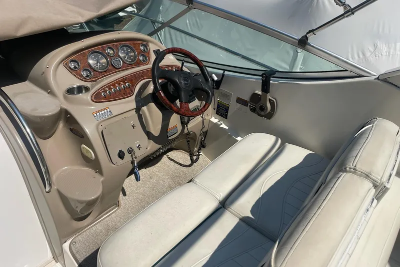 Slide: The Image of 2002 Maxum 2700 SCR boat cockpit with steering wheel and dashboard controls. - 4