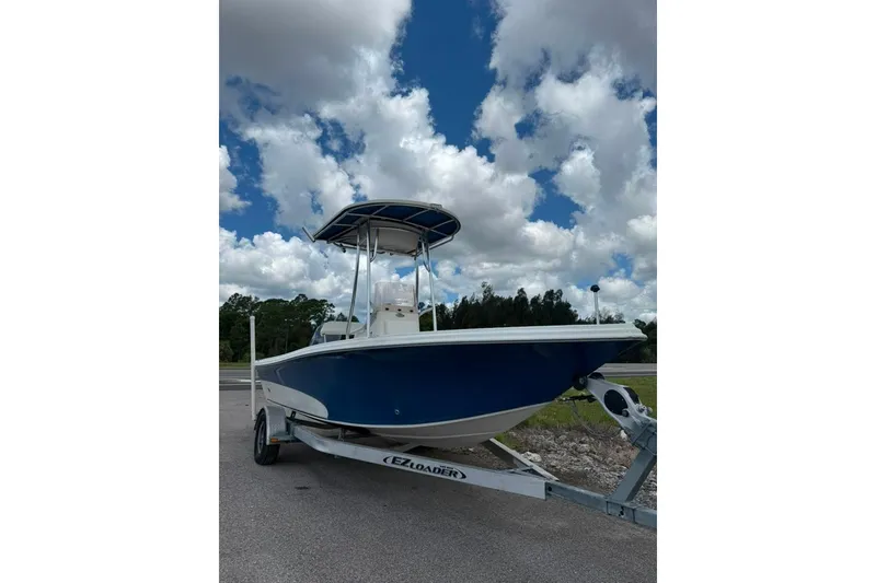 The Image of 2016 Sea Chaser 21 Sea Skiff boat on trailer under cloudy sky. - 3