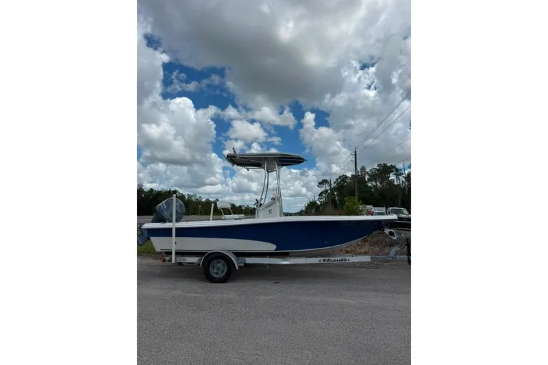 Slide: The Image of 2016 Sea Chaser 21 Sea Skiff boat on trailer under cloudy sky. - 4