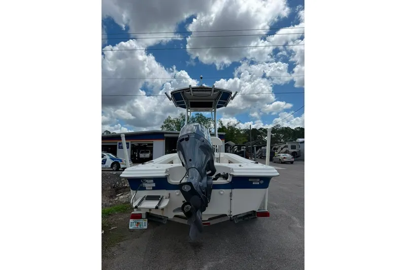 Slide: The Image of 2016 Sea Chaser 21 Sea Skiff boat with outboard motor, parked under cloudy sky. - 6