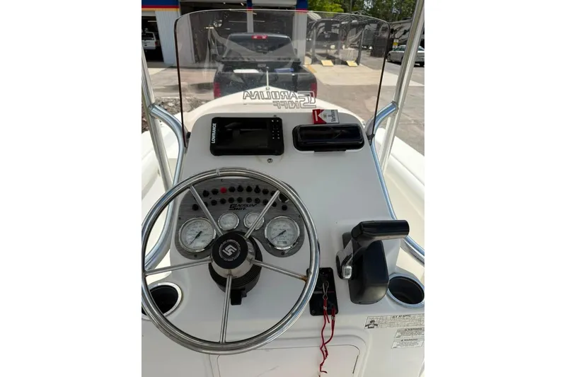 Slide: The Image of 2016 Sea Chaser 21 Sea Skiff boat console with steering wheel and gauges. - 8