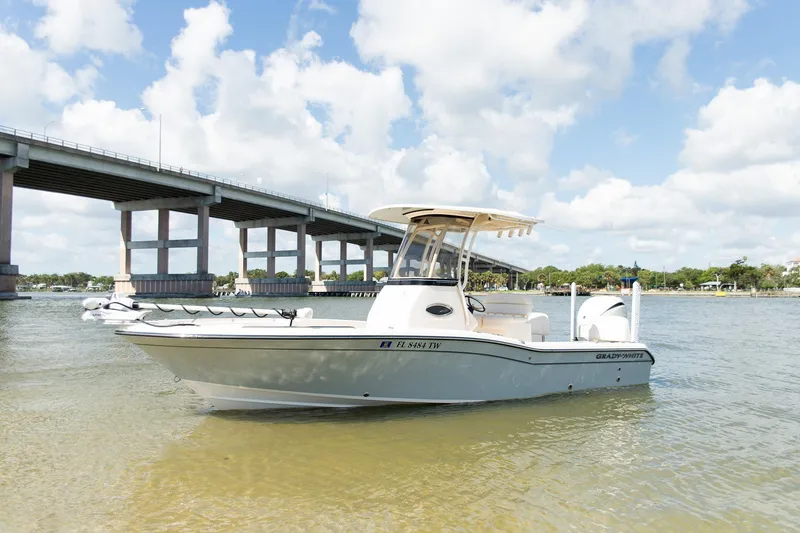 The Image of 2024 Grady-White 231 Coastal Explorer boat on water near a bridge under a blue sky. - 0
