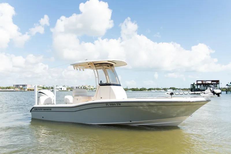 Slide: The Image of 2024 Grady-White 231 Coastal Explorer boat on calm water under a clear sky. - 1