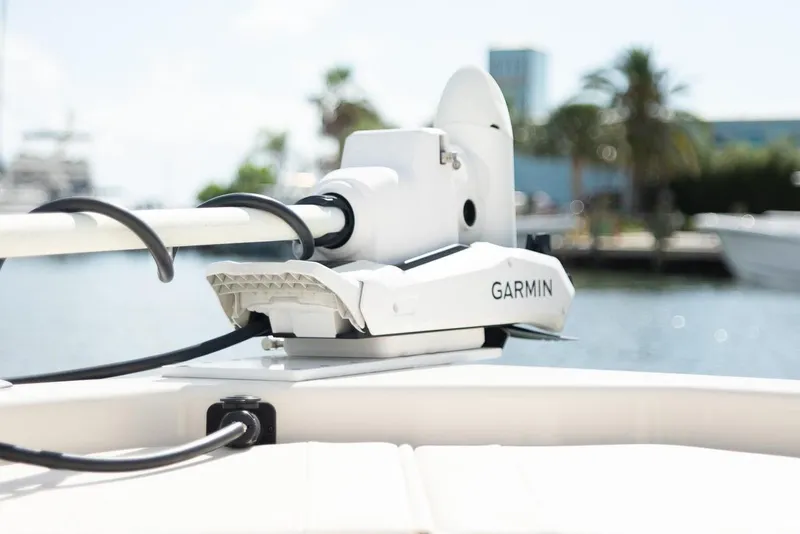 Slide: The Image of 2024 Grady-White 231 Coastal Explorer with Garmin equipment, docked near palm trees. - 11