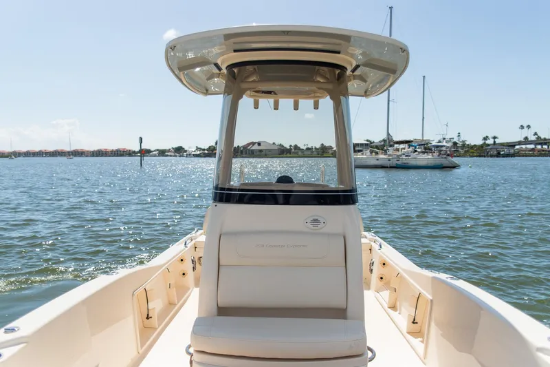 Slide: The Image of 2024 Grady-White 231 Coastal Explorer boat on calm waters, showcasing sleek design and spacious deck. - 15