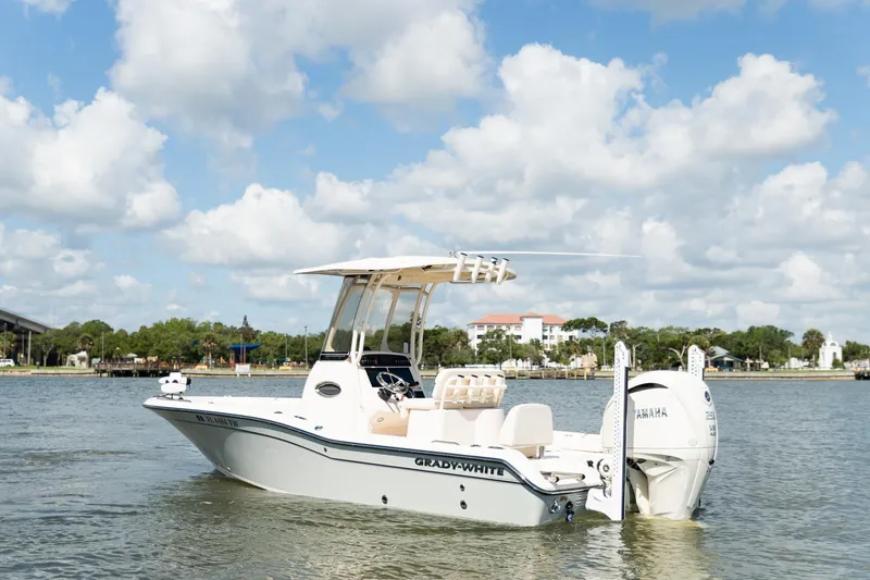 Slide: The Image of 2024 Grady-White 231 Coastal Explorer boat on water under a cloudy sky. - 2