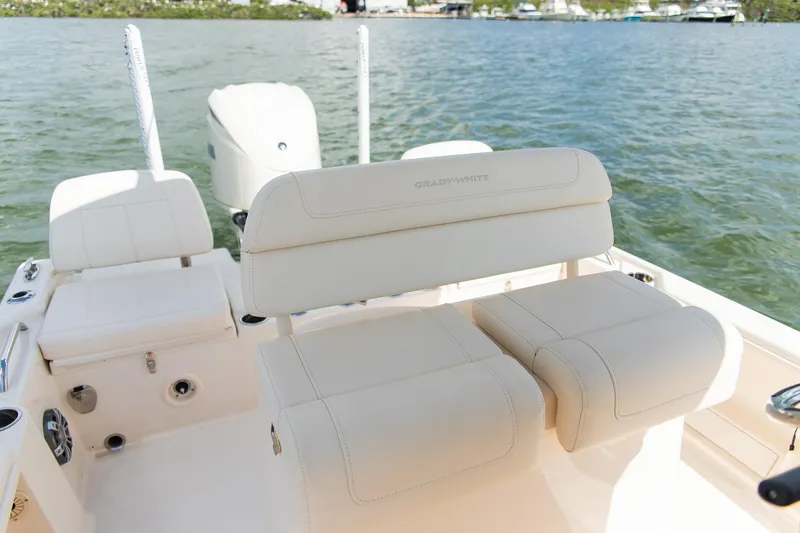 Slide: The Image of 2024 Grady-White 231 Coastal Explorer boat interior with plush seating on the water. - 23
