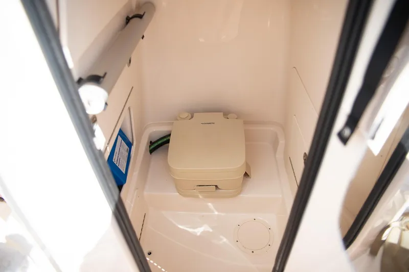 Slide: The Image of 2024 Grady-White 231 Coastal Explorer boat interior with portable toilet. - 25