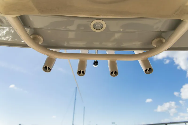 Slide: The Image of 2024 Grady-White 231 Coastal Explorer boat rod holders against blue sky. - 26
