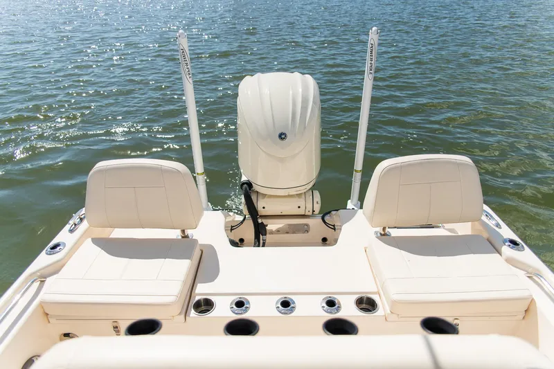 Slide: The Image of 2024 Grady-White 231 Coastal Explorer boat with dual seats and outboard motor on water. - 28