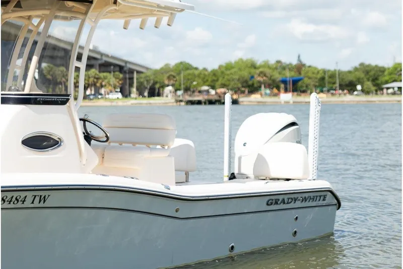 Slide: The Image of 2024 Grady-White 231 Coastal Explorer boat on calm water under a blue sky. - 6
