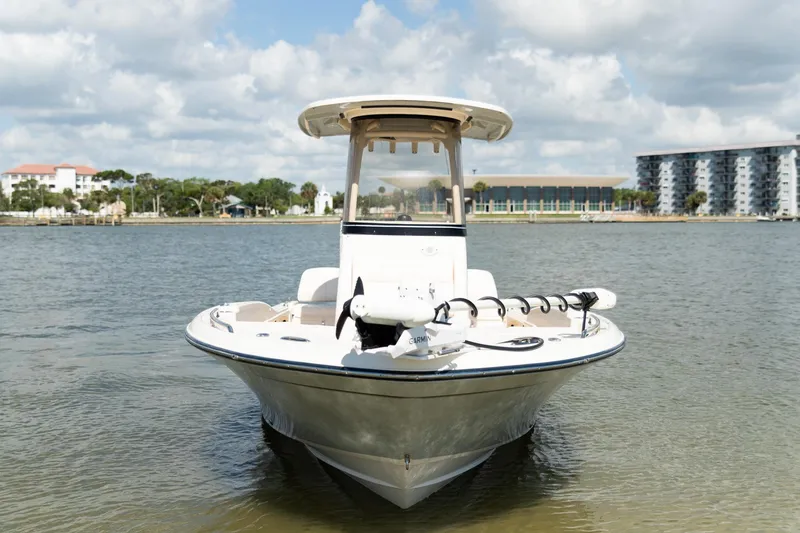 Slide: The Image of 2024 Grady-White 231 Coastal Explorer boat on water, with scenic background. - 7