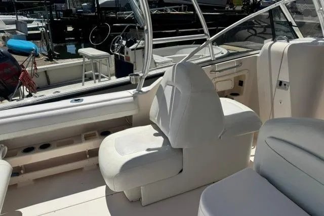 Slide: The Image of 2012 Grady-White Freedom 275 boat interior with white seating and helm station. - 11
