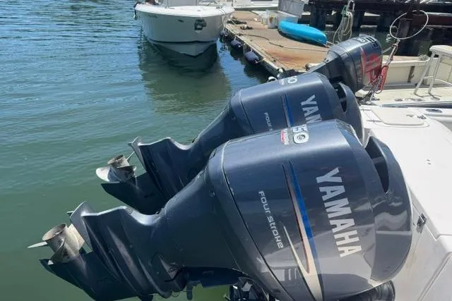 Slide: The Image of Twin Yamaha outboard engines on a 2012 Grady-White Freedom 275 boat at a dock. - 12