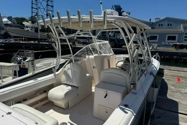 Slide: The Image of 2012 Grady-White Freedom 275 boat docked, featuring spacious seating and sturdy T-top. - 13