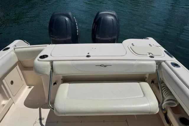 Slide: The Image of 2012 Grady-White Freedom 275 boat with dual engines and seating, on calm water. - 14