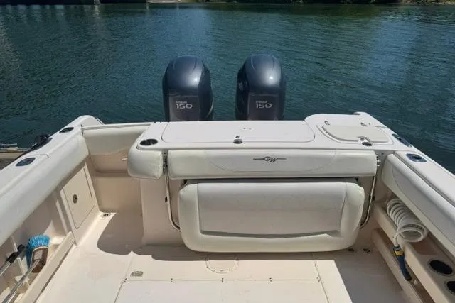 Slide: The Image of 2012 Grady-White Freedom 275 boat with twin 150 horsepower engines on a calm lake. - 15