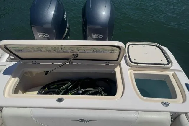 Slide: The Image of 2012 Grady-White Freedom 275 boat with Yamaha 150 engines and open storage compartments. - 16