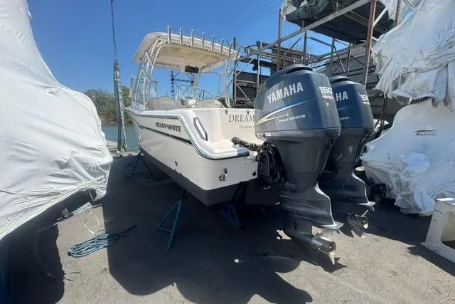 Slide: The Image of 2012 Grady-White Freedom 275 boat with twin Yamaha engines in storage. - 2