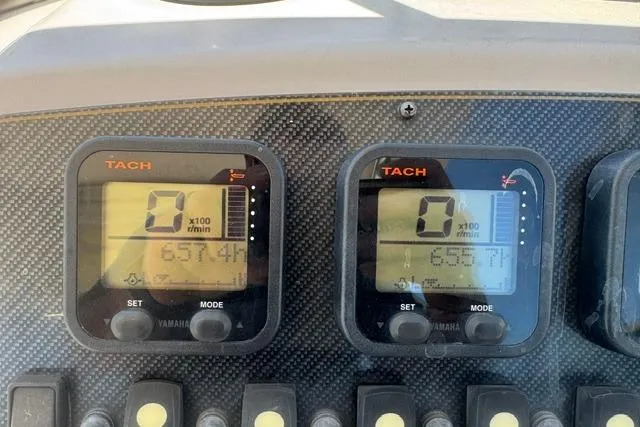 Slide: The Image of Dashboard of a 2012 Grady-White Freedom 275 boat showing tachometers. - 20