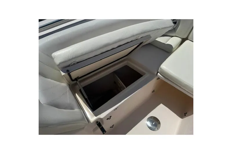 Slide: The Image of Open storage compartment on a 2012 Grady-White Freedom 275 boat with cushioned seating. - 29