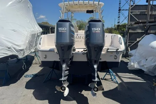 Slide: The Image of 2012 Grady-White Freedom 275 boat with twin Yamaha 150 engines, docked outdoors. - 4