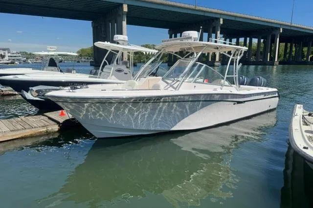 Slide: The Image of 2012 Grady-White Freedom 275 boat docked under a bridge on a sunny day. - 5