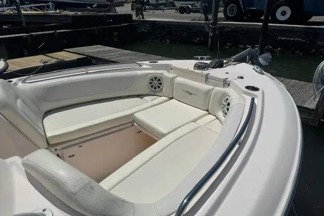 Slide: The Image of 2012 Grady-White Freedom 275 boat with spacious seating and sleek design at a dock. - 8