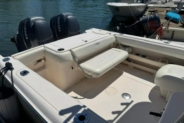 Slide: The Image of 2012 Grady-White Freedom 275 boat with Yamaha engines, docked on calm water. - 9