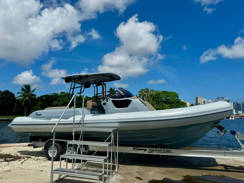 The Image of 2025 Ranieri CAYMAN 28 EXECUTIVE boat on trailer by waterfront, clear sky background. - 0