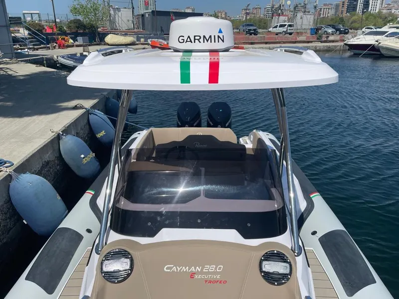 Slide: The Image of 2025 Ranieri CAYMAN 28 EXECUTIVE boat docked, featuring Garmin equipment and sleek design. - 4