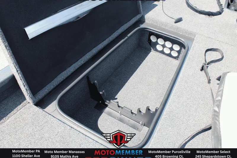 Slide: The Image of Open storage compartment in 2020 Ranger RT198P boat, featuring rod holders and carpeted interior. - 9
