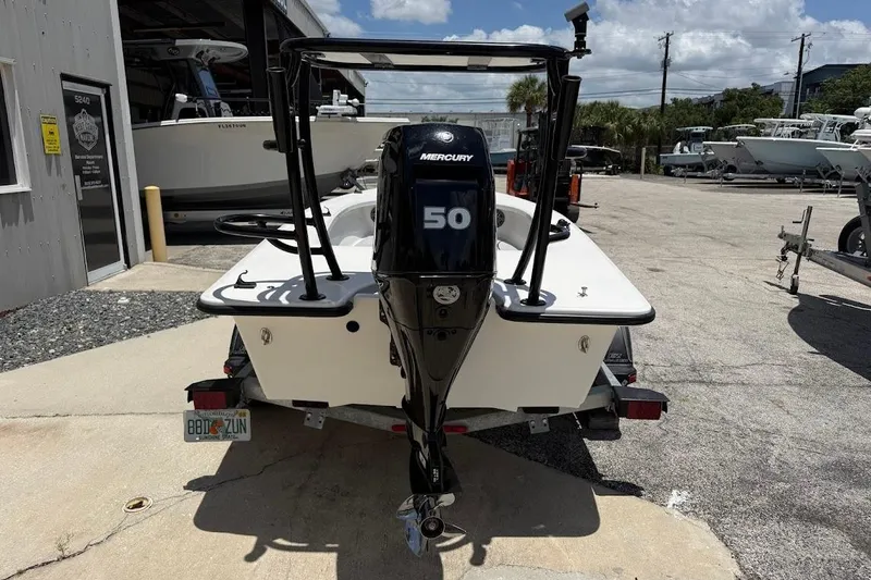 Slide: The Image of 2024 Delta D18 boat with Mercury 50 engine, parked outdoors. - 10