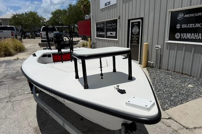 Slide: The Image of 2024 Delta Boatworks Delta D18 boat parked outside a dealership, showcasing sleek design. - 5