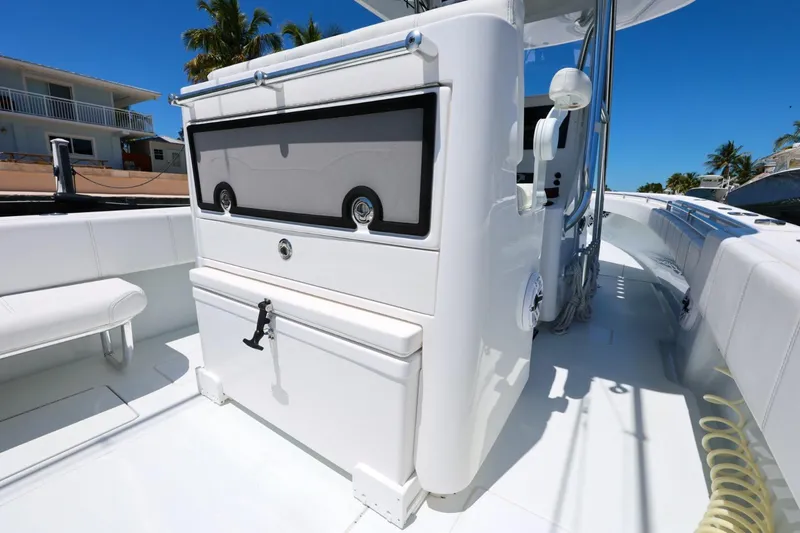 Slide: The Image of 2025 Contender 32 ST boat interior with sleek white seating and storage compartments. - 14