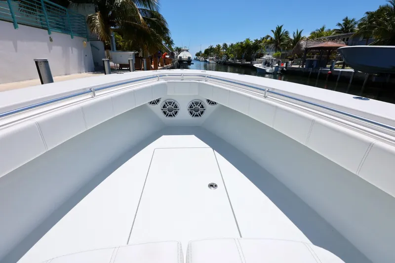 Slide: The Image of 2025 Contender 32 ST boat interior with sleek white seating and modern design. - 16