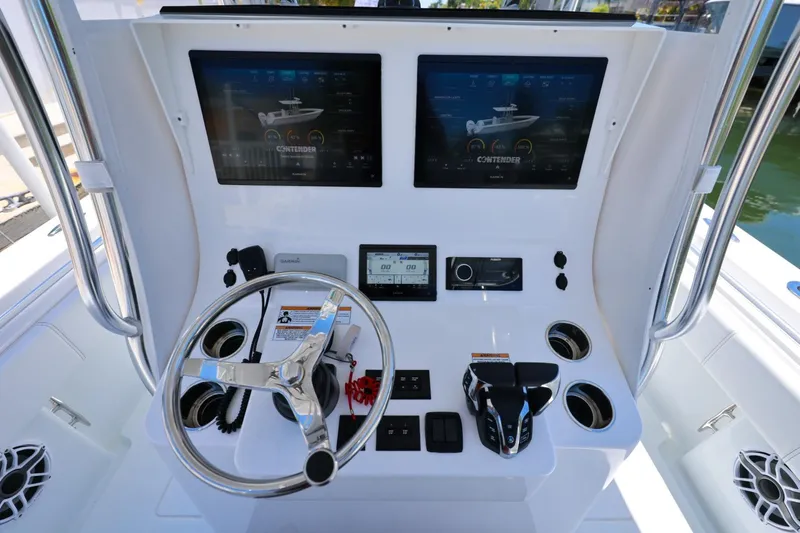 Slide: The Image of Center console of 2025 Contender 32 ST boat with dual screens and steering wheel. - 18