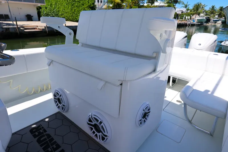 Slide: The Image of 2025 Contender 32 ST boat interior with white seating and built-in speakers. - 19