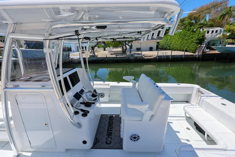 Slide: The Image of 2025 Contender 32 ST boat interior with sleek seating and modern controls. - 21