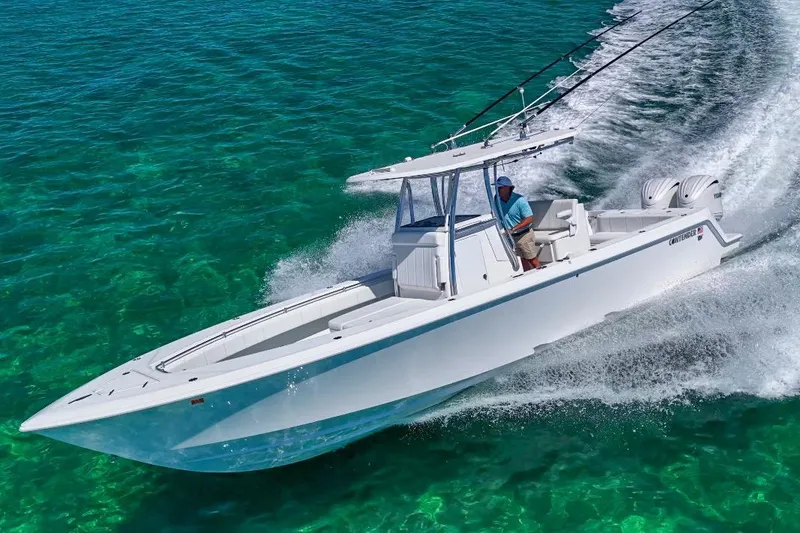 Slide: The Image of 2025 Contender 32 ST boat cruising on clear turquoise water. - 24