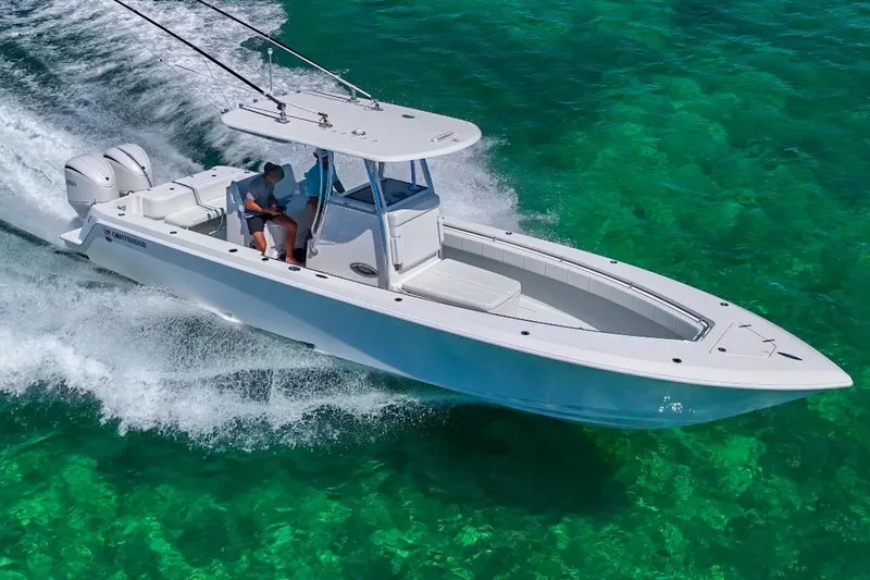 Slide: The Image of 2025 Contender 32 ST boat cruising on clear turquoise water. - 25