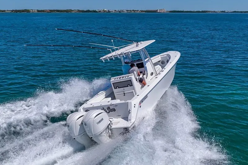 Slide: The Image of 2025 Contender 32 ST boat cruising on open water with dual Yamaha engines. - 27