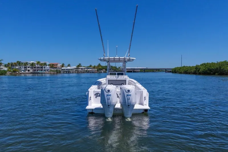 Slide: The Image of 2025 Contender 32 ST boat with dual engines on a sunny waterway. - 3
