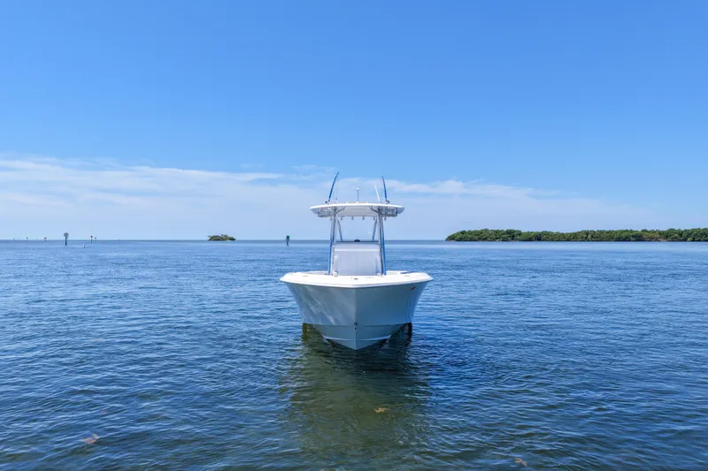 Slide: The Image of 2025 Contender 32 ST boat on calm blue ocean under clear sky. - 4