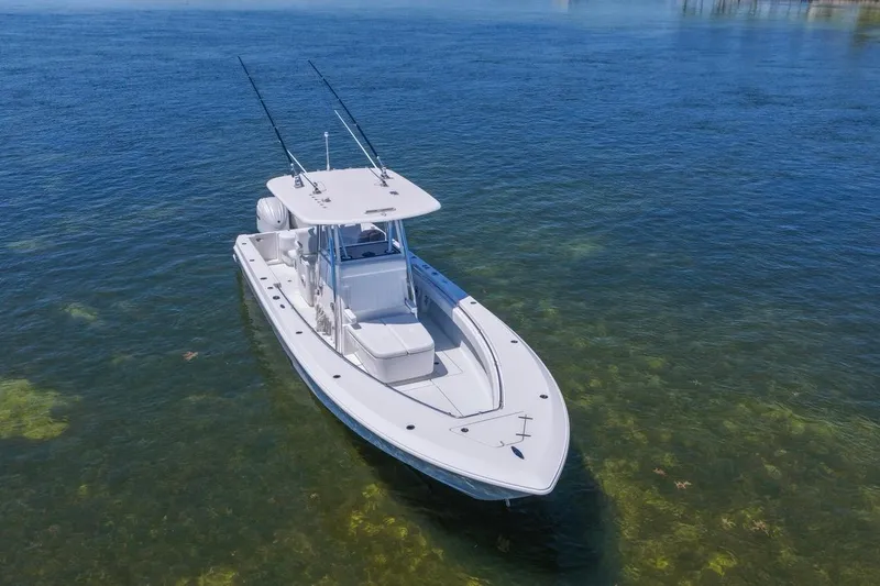 Slide: The Image of 2025 Contender 32 ST boat on clear blue water, aerial view. - 5