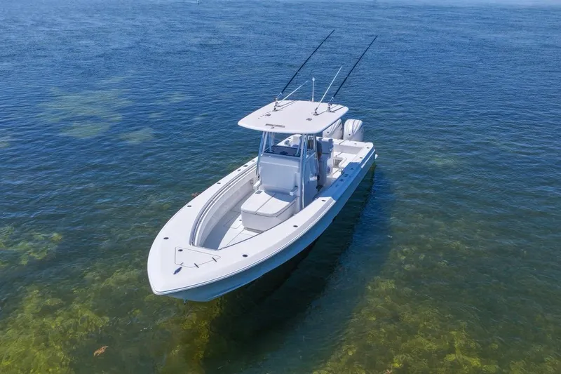 Slide: The Image of 2025 Contender 32 ST boat on clear blue water, showcasing sleek design and fishing capabilities. - 6
