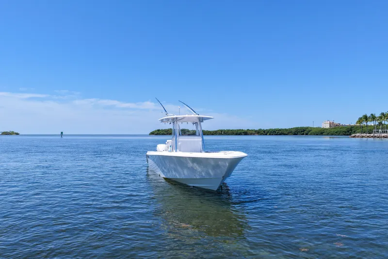 Slide: The Image of 2025 Contender 32 ST boat on calm blue water under clear sky. - 8