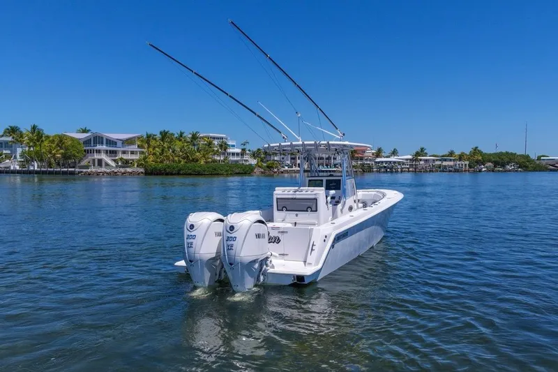Slide: The Image of 2025 Contender 32 ST boat with dual Yamaha engines on calm water. - 9