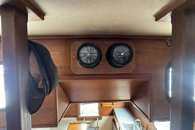 Slide: The Image of Interior of 1983 Nordic Tug 26 with wooden paneling and nautical instruments. - 10